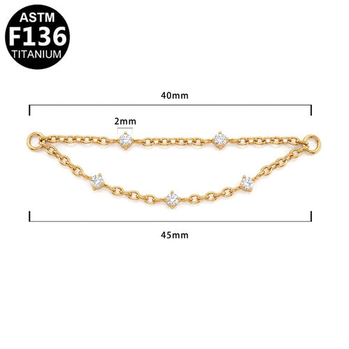 Gold chain with five clear round-cut stones, shown with dimension lines indicating a 40mm length, 2mm link spacing, and 45mm overall width.  ASTM F136 TITANIUM.