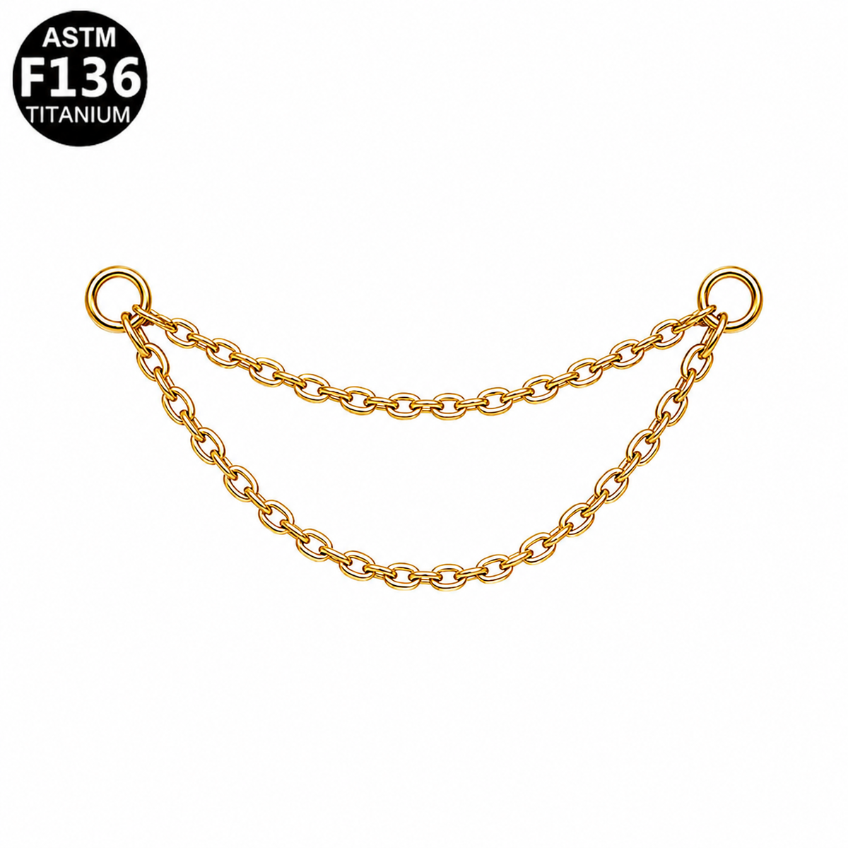 A gold-toned double-strand chain link accessory with two circular ring ends, shown on a plain white background with an ASTM F136 Titanium badge in the top-left corner.