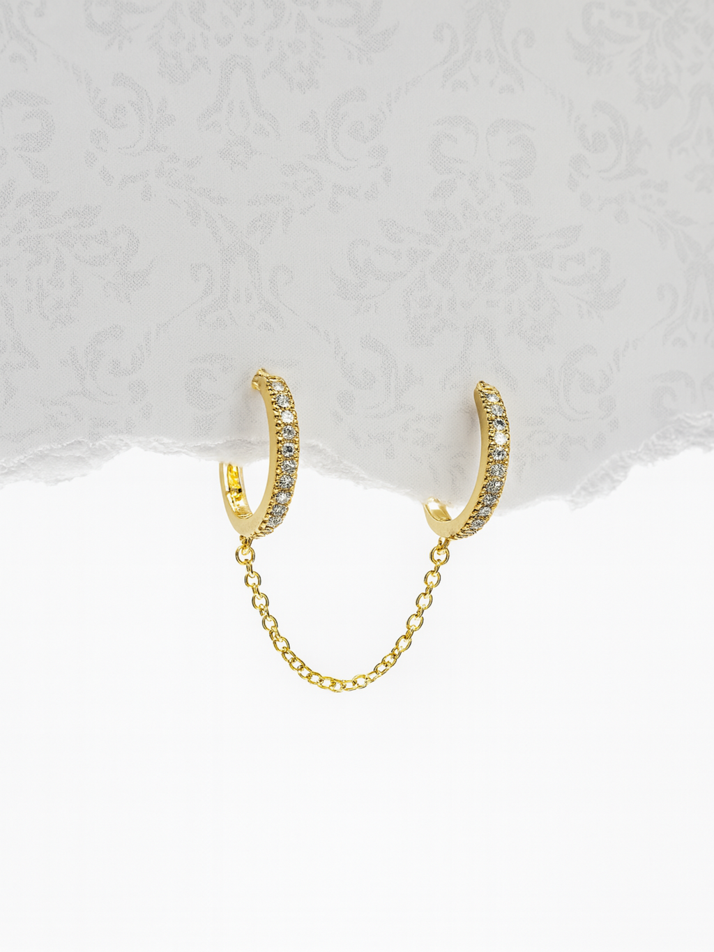 Gold hoop earrings with a chain 