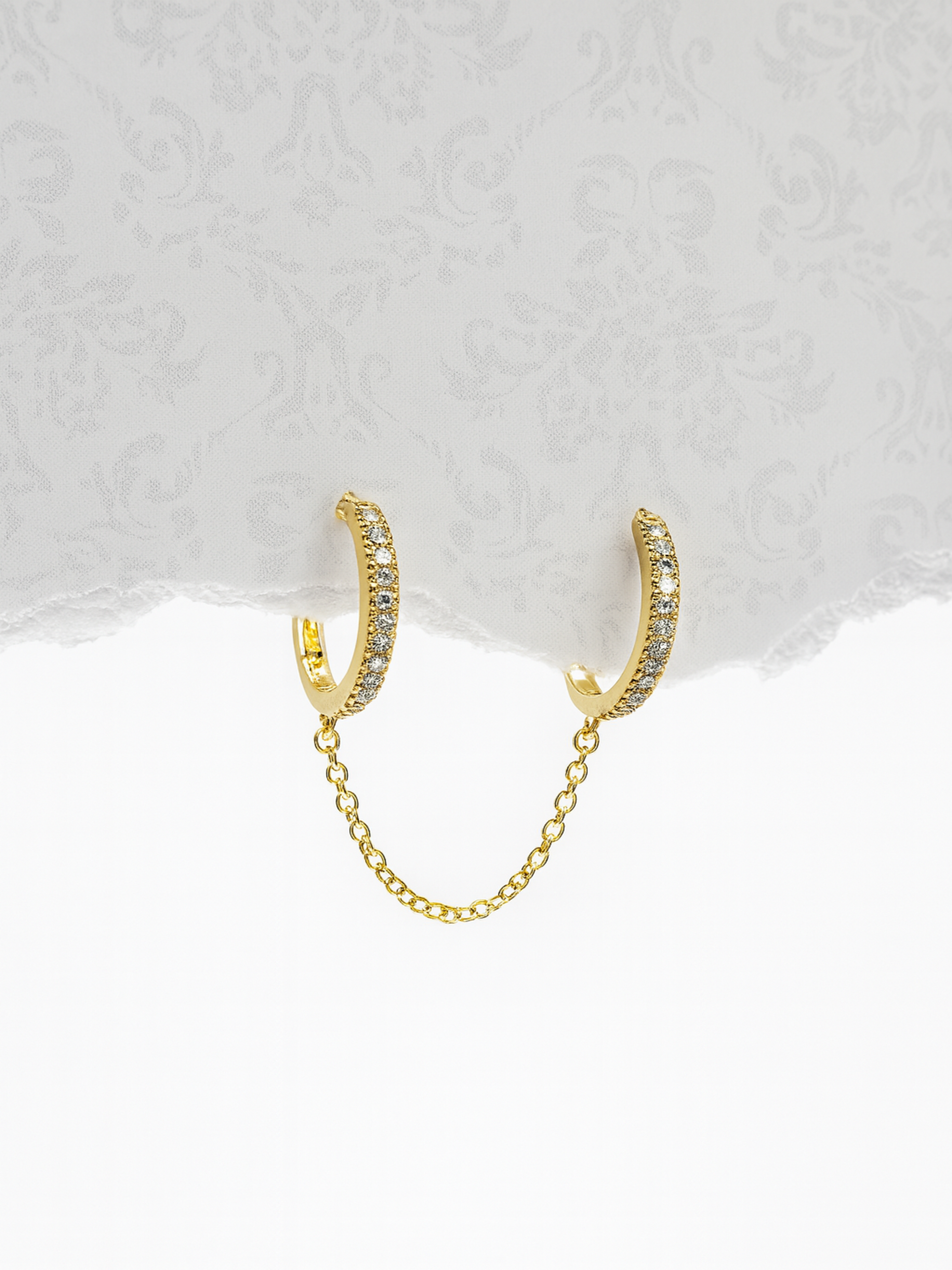 Gold hoop earrings with a chain 