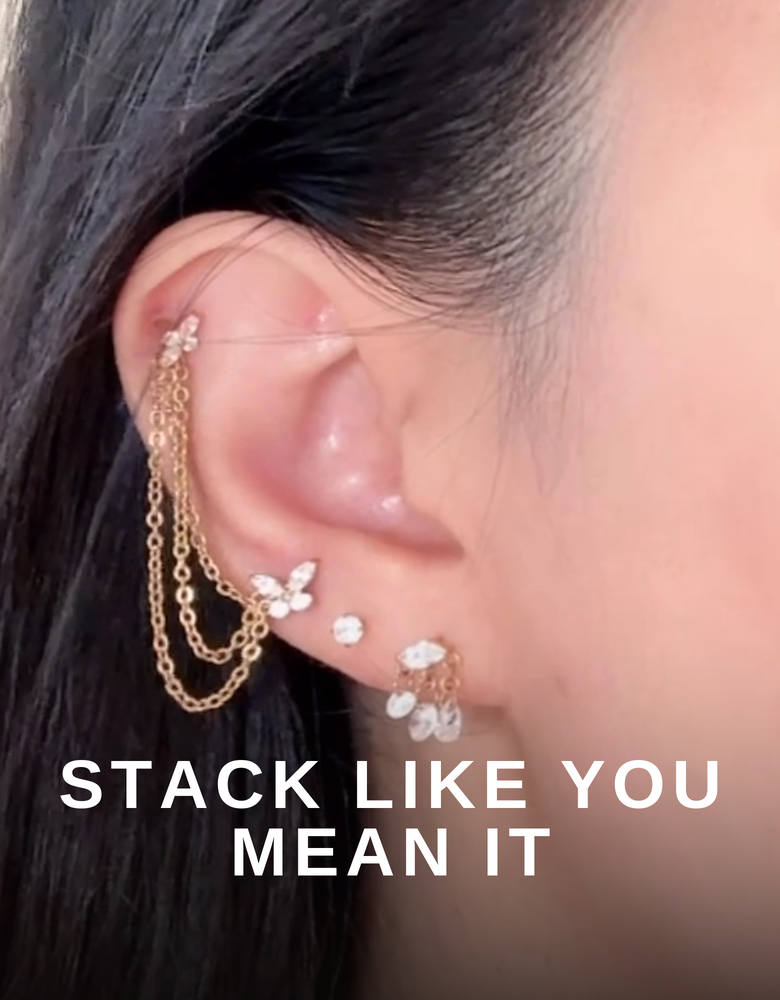 Petite Flutter butterfly stud in an ear stack with a chain connector and CZ drop earring